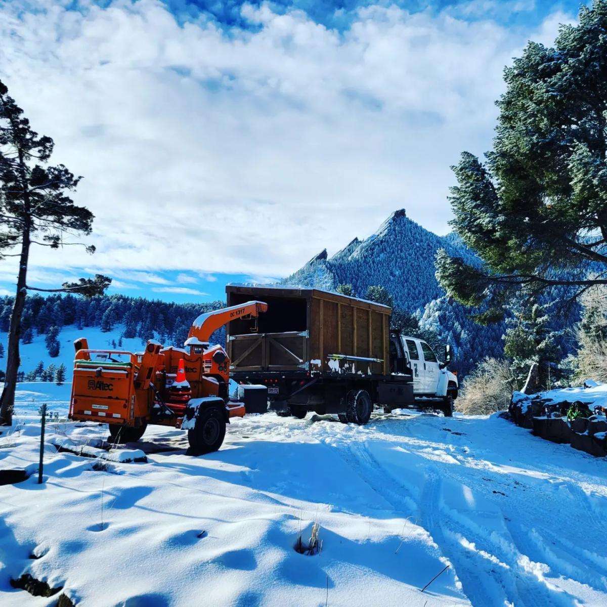 Snow-covered landscape with a truck and machinery.